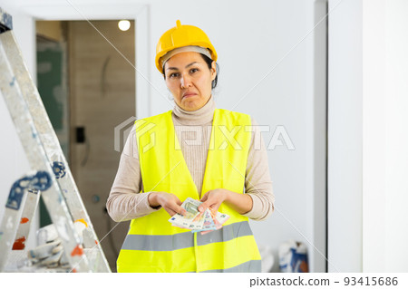 Woman builder frustrated by her wage Woman builder frustrated by her wage 93415686