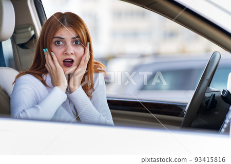 Closeup portrait of pissed off displeased angry aggressive woman driving a car shouting at someone. Negative human expression consept. Closeup portrait of pissed off displeased angry aggressive woman driving a car shouting at someone. Negative human expression consept. 93415816