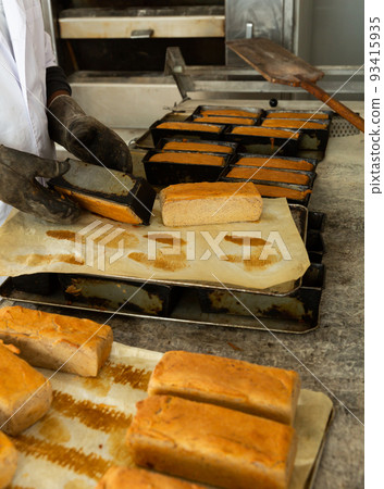 Taking out bread from baking molds Taking out bread from baking molds 93415935