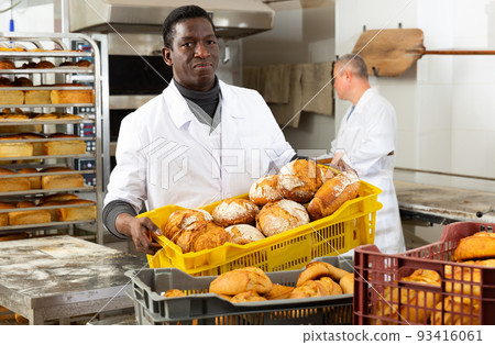 African baker carrying box with baked bread African baker carrying box with baked bread 93416061