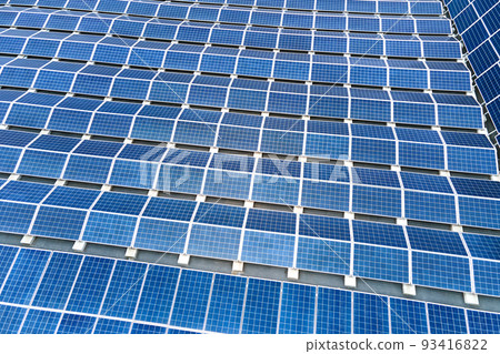 Aerial view of solar power plant with blue photovoltaic panels mounted on industrial building roof for producing green ecological electricity. Production of sustainable energy concept. 93416822