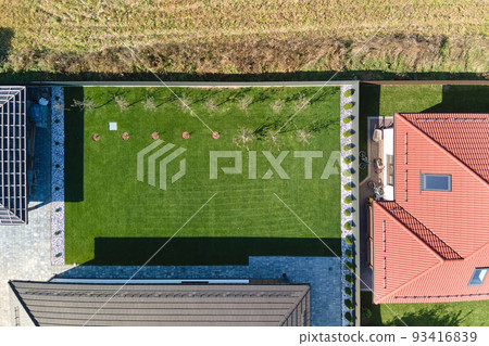 Aerial view of residential house with backyard in suburban rural area 93416839