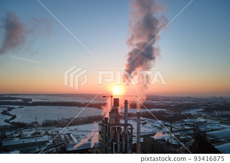 Aerial view of cement factory with high concrete plant structure and tower crane at industrial production area in evening. Manufacture and global industry concept Aerial view of cement factory with high concrete plant structure and tower crane at industrial production area in evening. Manufacture and global industry concept 93416875