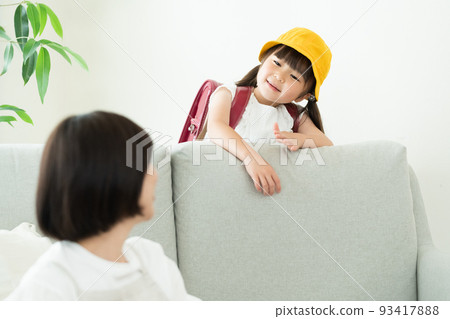 Elementary school girl who comes home and talks to mom 93417888