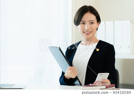 Lawyer woman doing desk work 93418589