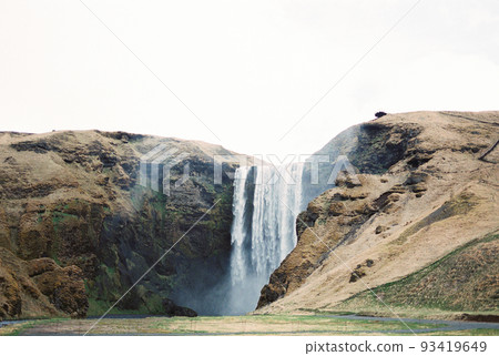 Waterfall in the rocky mountains above the valley. Iceland 93419649