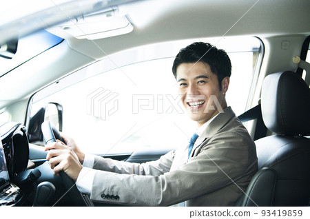 Male car driving looking at the camera smiling 93419859
