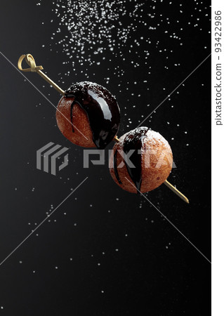 Doughnuts with chocolate sauce and sprinkled with sugar powder. Doughnuts with chocolate sauce and sprinkled with sugar powder. 93422986