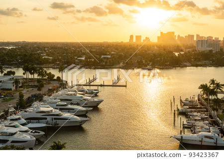 Luxury yacht parked on a canal with the sun coming down at Fort Lauderdale. Port of Fort Lauderdale with Sunset at the marina area 93423367