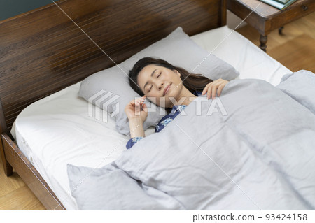 Middle-aged woman sleeping in bed Sleeping face 93424158