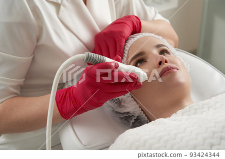 Rf lifting procedure in a beauty salon. Tightening and rejuvenation female face skin with RF-lifting session Rf lifting procedure in a beauty salon. Tightening and rejuvenation female face skin with RF-lifting session 93424344