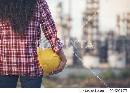 Woman worker hands holding hardhat yellow work helmet Construction Engineer. Refinery woman worker oil petro industry hand hold yellow worker helmet hard hat. Refinery industry engineer manufacture Woman worker hands holding hardhat yellow work helmet Construction Engineer. Refinery woman worker oil petro industry hand hold yellow worker helmet hard hat. Refinery industry engineer manufacture 93426175