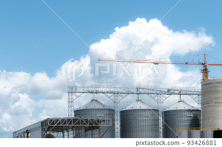 Animal feed factory construction site. Agricultural silo at feed mill factory. Tank for store grain in feed manufacturing. Seed stock tower for commercial animal feed production. Animal food industry. 93426881
