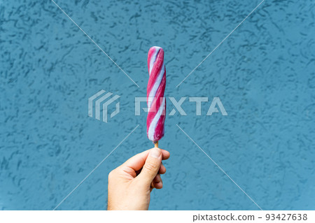 Ice cream cone in hand on minimal color background isolated. Summer, food, sweets, ice cream concept. 93427638