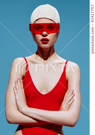 A girl with a MarsaY in a red swimsuit with glasses folding her hands looks at the camera. The art of the new generation of NFT 93427767