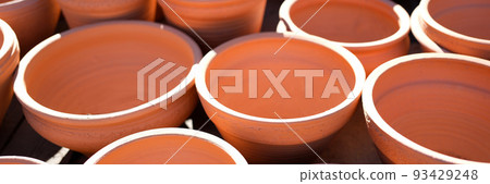 Lot of clay pots for sale on street background closeup Lot of clay pots for sale on street background closeup 93429248