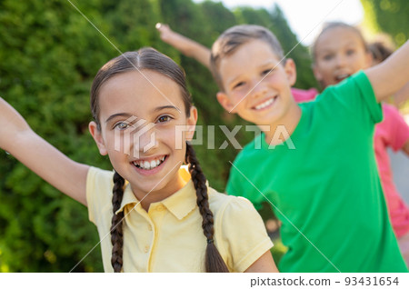 Girls and boys having fun outdoors Girls and boys having fun outdoors 93431654