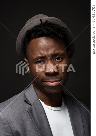 Portrait of attractive young black male studio on dark background Portrait of attractive young black male studio on dark background 93433705