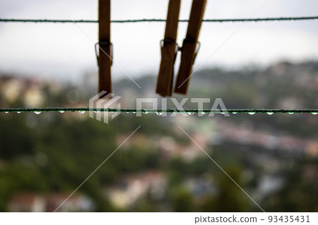 Rain drops on clothesline. Wet Laundry Pegs 93435431