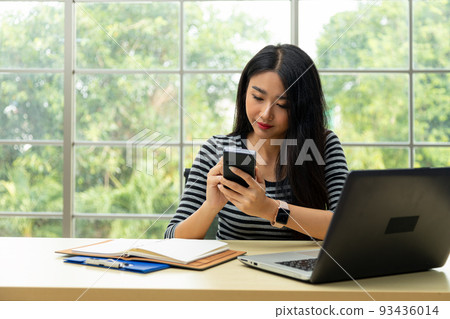 Asian woman hands using stylus pen writing on personnal pda to check information Asian woman hands using stylus pen writing on personnal pda to check information 93436014