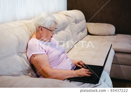 Senior mature older woman watching business training, online webinar on laptop computer remote working or social distance learning from home. 60s businesswoman video conference calling in virtual chat 93437222