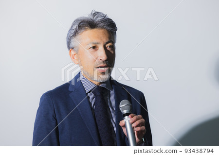 A man with gray hair giving a speech 93438794