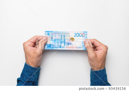 Men's hands hold 2000 rubles to pay for gas on a white background. The concept of using rubles to pay for products and services 93439156