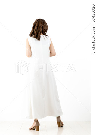 Rear view of a young woman wearing a white dress 93439320