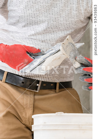Lime plaster on a spatula, repair and decoration work with lime plaster, two dirty spatulas. 93439863