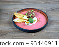 Plate with steak, quail egg with croutons and omelette. 93440911