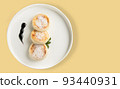 A plate with a morning breakfast - cheesecakes on a yellow background. 93440931