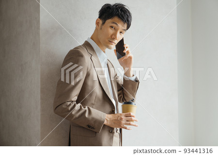 Businessman by the window of a skyscraper Businessman by the window of a skyscraper 93441316