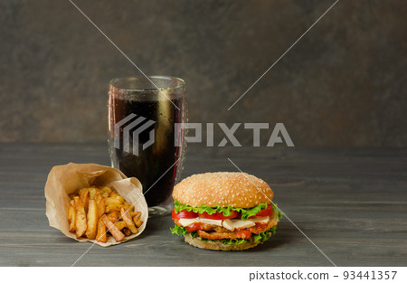 Hamburger, french fries and cola on table with wooden background. 93441357