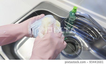 Housewife washing dishes in the kitchen 93441681