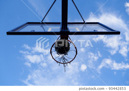 Street basketball ball falling into the hoop. 93442853