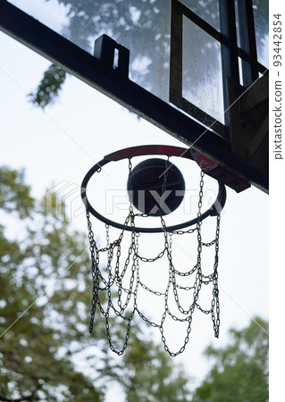 Street basketball ball falling into the hoop. 93442854