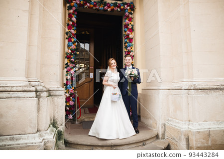 Married couple posing in a church after ceremony Married couple posing in a church after ceremony 93443284