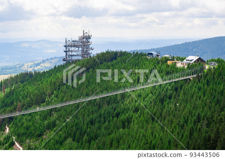 Sky walk observation tower in the forest between mountain hills near Sky Bridge 721 in a sunny summer day, Dolni Morava, Czech Republic. Sky walk observation tower in the forest between mountain hills near Sky Bridge 721 in a sunny summer day, Dolni Morava, Czech Republic. 93443506