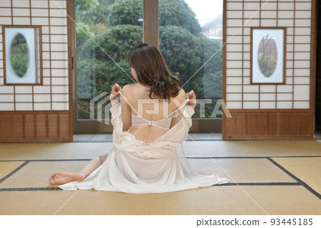 Back view of a young woman wearing white lingerie sitting in a Japanese-style room in an old folk house Back view of a young woman wearing white lingerie sitting in a Japanese-style room in an old folk house 93445185