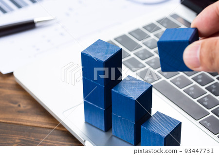 Graphs, business documents and a computer Graphs, business documents and a computer 93447731