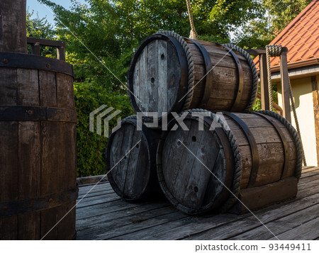 three wooden barrels on the deck 93449411