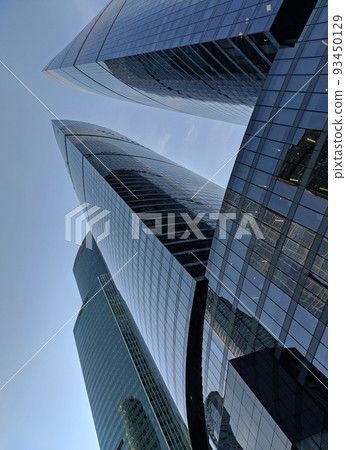 Bottom view on skyscrapers and blue sky in Moscow City, Russia. Modern office buildings in the financial district. Abstract background. High quality photo. Bottom view on skyscrapers and blue sky in Moscow City, Russia. Modern office buildings in the financial district. Abstract background. High quality photo. 93450129