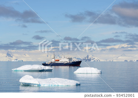 Expedition ship with iceberg in Antarctic sea aerial view  93452001