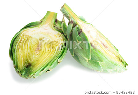 two halves of ripe green artichokes on a white background two halves of ripe green artichokes on a white background 93452488