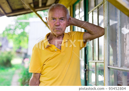 Portrait of an elderly man 70 years old in his garden on summer sunny day Portrait of an elderly man 70 years old in his garden on summer sunny day 93452804