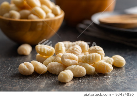 Uncooked potato gnocchi on kitchen table. Tasty italian food. Uncooked potato gnocchi on kitchen table. Tasty italian food. 93454850