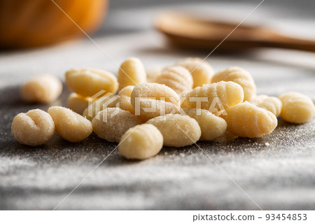 Uncooked potato gnocchi on kitchen table. Tasty italian food. Uncooked potato gnocchi on kitchen table. Tasty italian food. 93454853