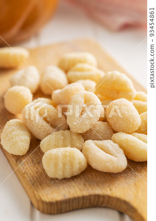 Uncooked potato gnocchi on cutting board. Tasty italian food. Uncooked potato gnocchi on cutting board. Tasty italian food. 93454861