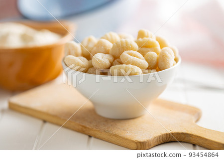 Uncooked potato gnocchi in bowl. Tasty italian food. Uncooked potato gnocchi in bowl. Tasty italian food. 93454864