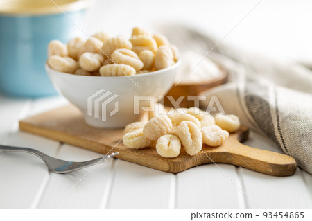 Uncooked potato gnocchi on cutting board. Tasty italian food. Uncooked potato gnocchi on cutting board. Tasty italian food. 93454865